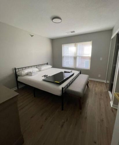 a bedroom with a bed and a couch and a window at Aksarben Gem- WFH corner desk & minutes from I-80 in Omaha