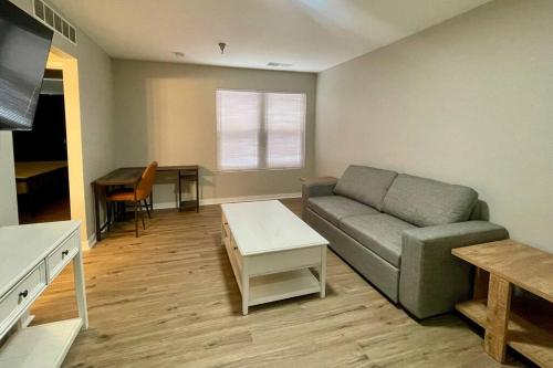 a living room with a couch and a table at Aksarben Gem- WFH corner desk & minutes from I-80 in Omaha