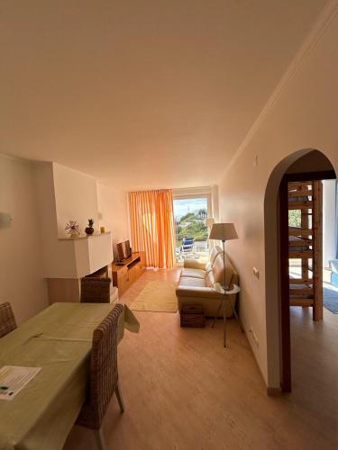 a living room with a table and a couch at Apartment with Breathtaking view in Praia da Areia Branca