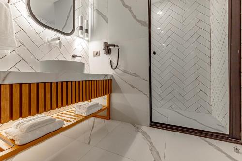 a bathroom with a shower and a sink at Dulcet Hotel in Antalya