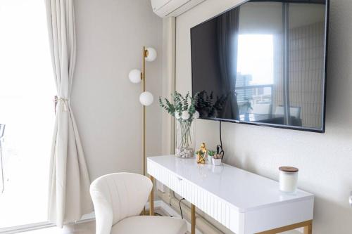 a white table with a mirror and a white chair at Waikiki Beach 1Bedroom Luxury Condo! in Honolulu