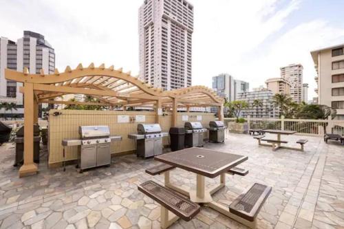 a patio with a barbecue grill and a gazebo at Waikiki Beach 1Bedroom Luxury Condo! in Honolulu