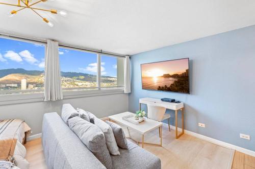 a living room with a couch and a table at Waikiki Beach 1Bedroom Luxury Condo! in Honolulu