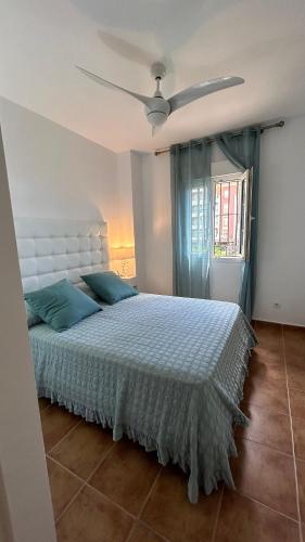 a bedroom with a bed and a ceiling fan at Apartamento 2 dormitorios Isla Canela in Isla Canela