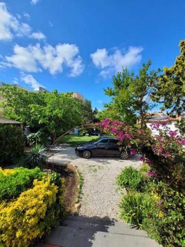 a car parked in a parking lot with flowers at VillaVittorio in Tarquinia