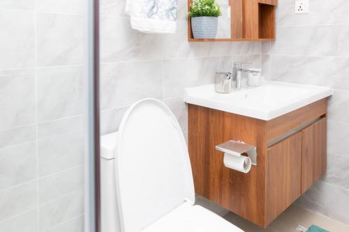a bathroom with a toilet and a sink and a shower at Serenity Haven - Gated Pool WiFi Sea View in Agblesia
