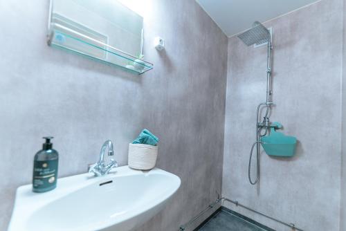 a bathroom with a sink and a shower at Hjelmeland Camping & Hostel Nøkling in Hjelmeland