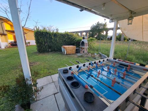 a pool game on a table in a yard at Glamping Villa Ungaretti in Guamo