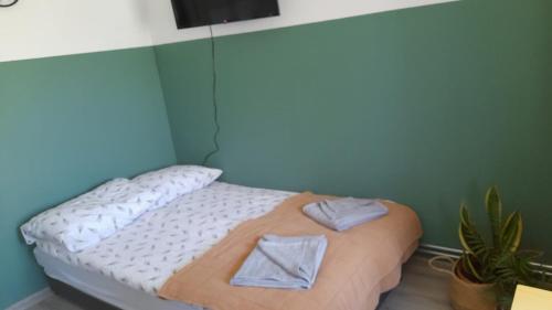 a bedroom with a bed with towels on it at Apartament u Krystynki in Kętrzyn