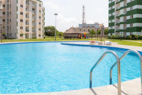 a large swimming pool in the middle of a building at Serenity Haven - Gated Pool WiFi Sea View in Agblesia