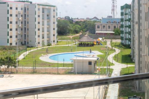 a view of a playground from a building at Serenity Haven - Gated Pool WiFi Sea View in Agblesia