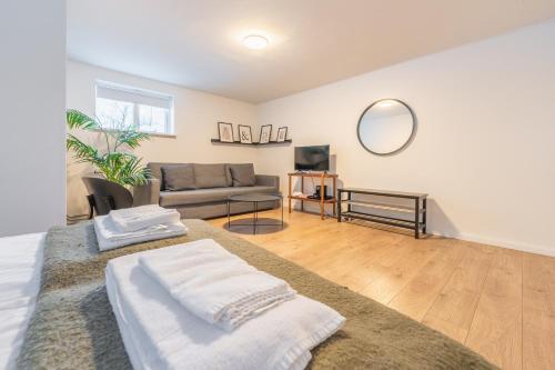 a living room with a couch and a table at Day Dream Soleyjargata Rooms & Apartments in Reykjavík