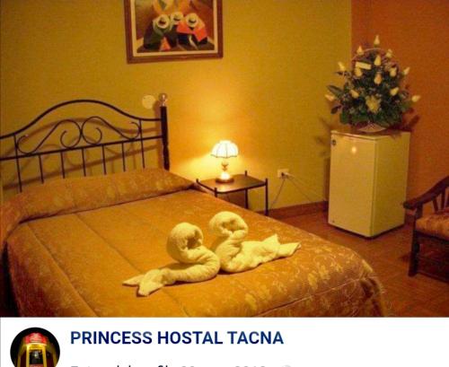 due peluche sedute su un letto in una camera da letto di PRINCESS a Tacna