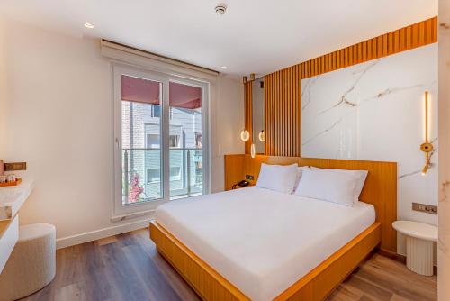 a bedroom with a large bed and a window at Dulcet Hotel in Antalya