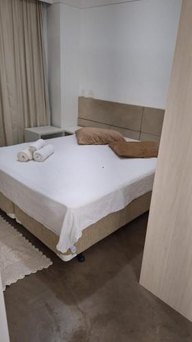 a bedroom with a large bed with towels on it at FLAT HOTEL EM ALPHAVILLe ÓTIMA LOCALIZAÇÃO in Barueri