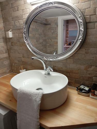 a bathroom with a white sink and a mirror at Vasiliki Skyros Castle View in Skiros