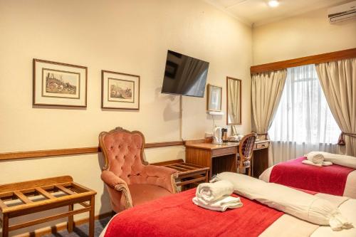 Ένα ή περισσότερα κρεβάτια σε δωμάτιο στο Karoo Country Inn