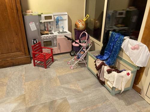 a toy kitchen with a doll house and a refrigerator at Lou Raspaillou in Issigeac