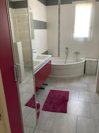 a bathroom with a tub and a sink and a bath tub at Lou Raspaillou in Issigeac
