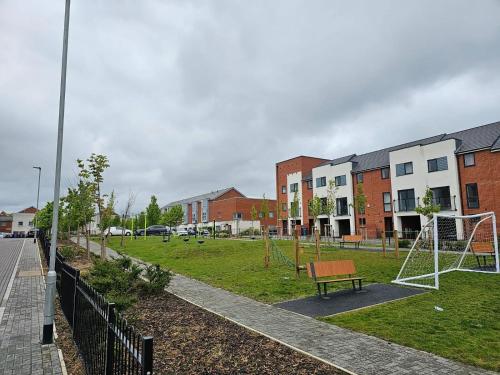 a park with a playground with a swing at Modern 3 Bedroom Town House in Ipswich