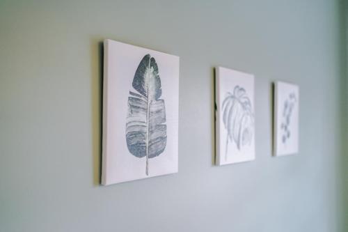 three framed prints of a leaf on a wall at Modern Semi detached in a quiet location, Driveway parking in Ewloe