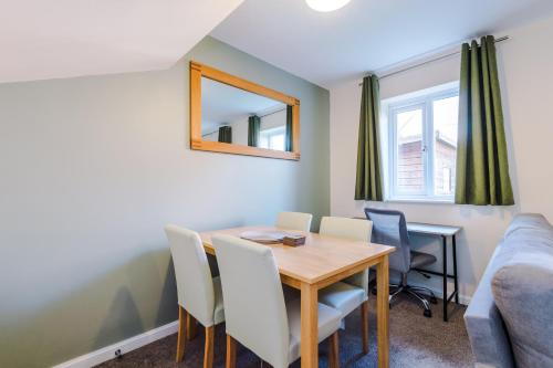 a dining room with a table and chairs at Modern Semi detached in a quiet location, Driveway parking in Ewloe