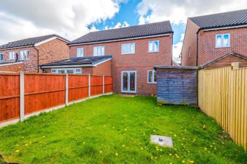 a backyard of a house with a fence at Modern Semi detached in a quiet location, Driveway parking in Ewloe