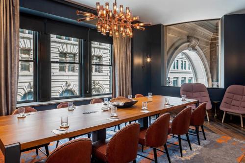a conference room with a long table and chairs at The Industrialist Hotel, Pittsburgh, Autograph Collection in Pittsburgh