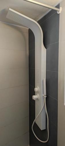 a shower in a bathroom with a phone on the wall at Φωλιά in Olympos