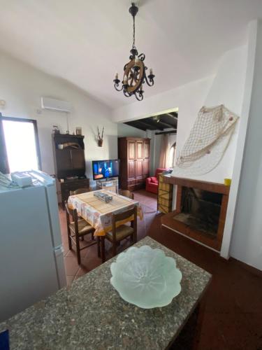 a living room with a table and a fireplace at Casetta Marina Residence in Santa Luria