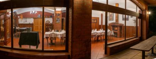 a dining room with tables and chairs in a restaurant at Arco penzion in Vítkovice