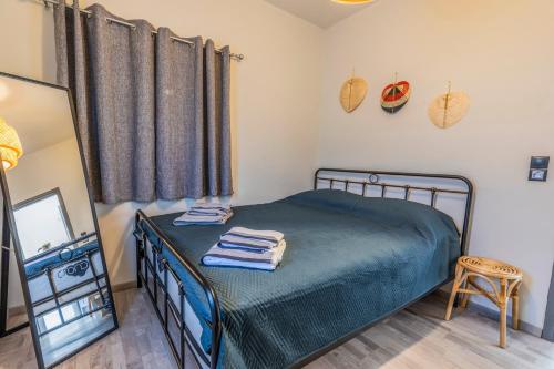 a bedroom with a bed and a mirror and a chair at Cosy Cottage in Stalida