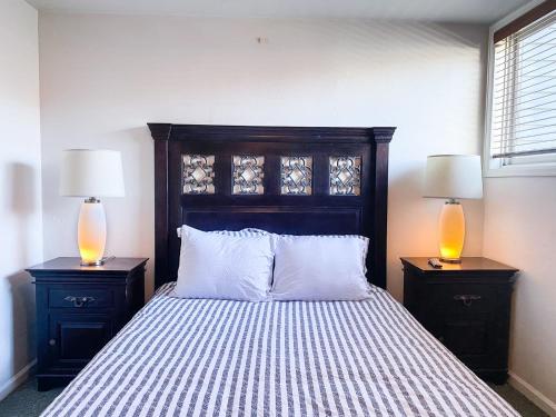 a bedroom with a bed with two lamps on night stands at Telluride Lodge Your mountain gateaway in Telluride