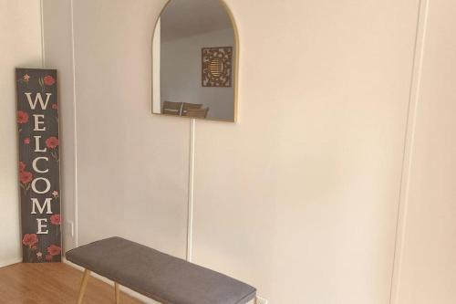 a mirror on a wall next to a chair at Sea Island Seclusion Marsh View with Beach Pass in St. Helena Island