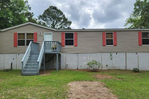 a house with a staircase in front of it at Sea Island Seclusion Marsh View with Beach Pass in St. Helena Island