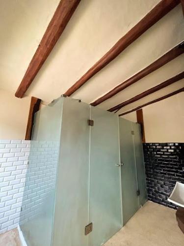 a bathroom with a shower with a glass door at Alquimia Hotel Boutique in Tulum