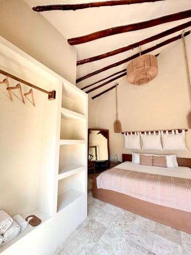 a bedroom with a bed and shelves in it at Alquimia Hotel Boutique in Tulum