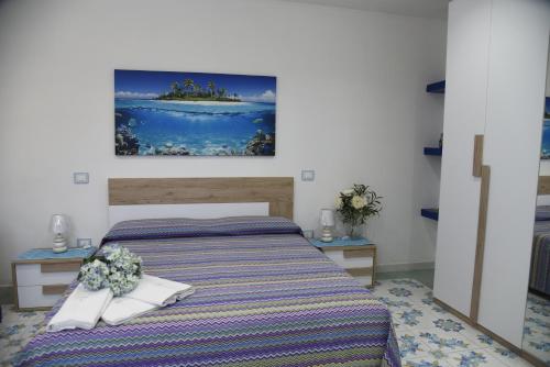 a bedroom with a bed and two night stands at La Laura di Paestum - case vacanze in Capaccio-Paestum