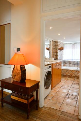 a living room with a table with a lamp on it at Villa Filoxenia all seasons, near airport, sea, Athens in Aghia Marina