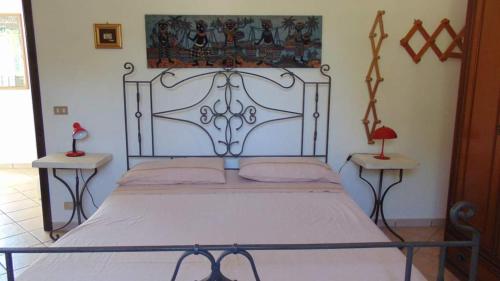 een slaapkamer met een groot bed met een metalen frame bij Trullo Oasi di Pace in Ceglie Messapica