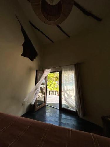 a bedroom with a window and a bed in a room at Alquimia Hotel Boutique in Tulum