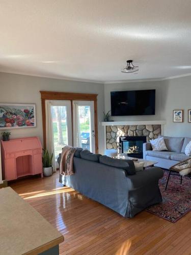 a living room with a couch and a fireplace at Cosy Chalet - 4 Season Family Oasis in Collingwood