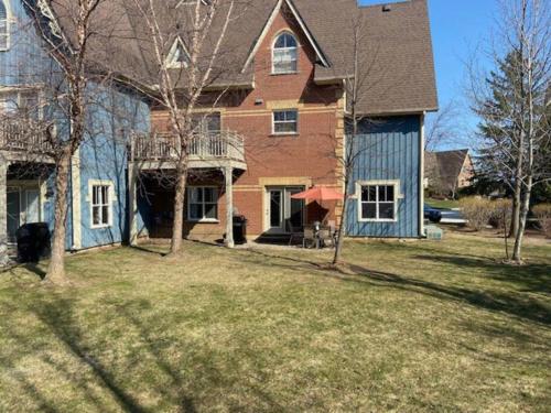 a large house with a large yard with a house at Cosy Chalet - 4 Season Family Oasis in Collingwood