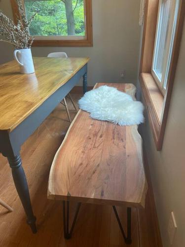 a wooden desk with a stool with a white pillow on it at Cosy Chalet - 4 Season Family Oasis in Collingwood