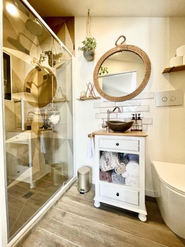 a bathroom with a sink and a mirror at Stunning cottage in Christchurch