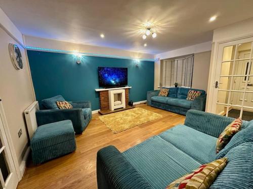 a living room with two couches and a tv at Accessible home in Sherwood in Nottingham