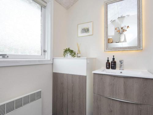 a bathroom with a sink and a mirror at Holiday home Struer XI in Struer