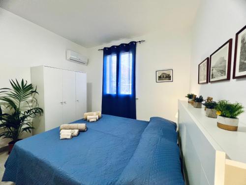 a bedroom with a blue bed with two pillows on it at L'Angolo del Saraceno in Carini