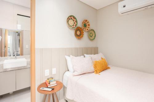 a bedroom with a bed and a sink and a mirror at MARENOSTRUM -VISTA MAR - PRAIA DOS CARNEIROS - ECO RESORT- 2 Suítes in Praia dos Carneiros