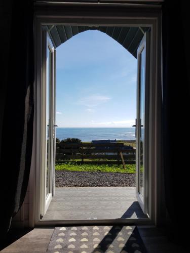 an open door with a view of the ocean at Bruadarach 'Visionary, Dreamer' in Dunbeath